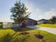 Quaint single-Gathering home with tidy landscaping and a smooth driveway, set under a clear blue sky at 1155 Towergate Cir, Lake Wales, FL 33853