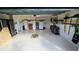 Spacious garage featuring painted walls, epoxy flooring, and ample storage solutions at 1155 Towergate Cir, Lake Wales, FL 33853