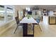 Bright living and dining area with large windows, modern furnishings, and tile flooring at 1155 Towergate Cir, Lake Wales, FL 33853