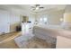 Bright bedroom features wood-look floors, ensuite bathroom, ceiling fan, and private balcony access at 1155 Towergate Cir, Lake Wales, FL 33853