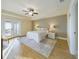 Bright and airy main bedroom with en-suite bathroom, ceiling fan, and French door access at 1155 Towergate Cir, Lake Wales, FL 33853