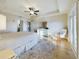Bright bedroom features wood-look floors, ensuite bathroom, ceiling fan, and private balcony access at 1155 Towergate Cir, Lake Wales, FL 33853