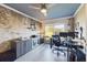 Home office with unique brick accent wall, modern desk, and ample natural light at 1155 Towergate Cir, Lake Wales, FL 33853