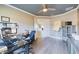 Bright office space featuring a ceiling fan, ample workspace, and natural light from the hallway entry at 1155 Towergate Cir, Lake Wales, FL 33853