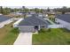 One-story house with gray roof and white fence, in a residential area at 1225 Third Ct, Eagle Lake, FL 33839