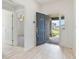 Bright entryway with dark gray door, light flooring, and views to other rooms at 1225 Third Ct, Eagle Lake, FL 33839