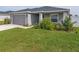 Single-story house with gray siding, gray garage door, and well-manicured lawn at 1225 Third Ct, Eagle Lake, FL 33839