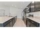 Open concept kitchen with dark cabinetry and stainless steel appliances at 1225 Third Ct, Eagle Lake, FL 33839
