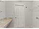 Bright laundry room with built-in shelving and countertop at 1225 Third Ct, Eagle Lake, FL 33839