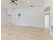 Open living room with light gray walls, wood-look floors, and ceiling fan at 1225 Third Ct, Eagle Lake, FL 33839