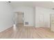 Spacious living room with light wood-look flooring and an arched hallway at 1225 Third Ct, Eagle Lake, FL 33839