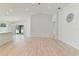 Open living area with high ceilings, wood-look floors, and access to kitchen at 1225 Third Ct, Eagle Lake, FL 33839