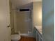 Bathroom featuring a walk-in shower, updated vanity, and wood-look vinyl flooring at 1610 Reynolds Rd # 211, Lakeland, FL 33801