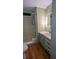 Bathroom featuring a walk-in shower, updated vanity, and wood-look vinyl flooring at 1610 Reynolds Rd # 211, Lakeland, FL 33801