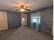 Cozy bedroom featuring neutral carpet, ceiling fan, and ensuite bathroom access at 1610 Reynolds Rd # 211, Lakeland, FL 33801