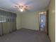 This bedroom features neutral colored carpet and a view to the hallway at 1610 Reynolds Rd # 211, Lakeland, FL 33801