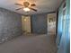 Bright bedroom featuring neutral carpet, ceiling fan, and ensuite bathroom access at 1610 Reynolds Rd # 211, Lakeland, FL 33801