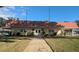 Charming community building with a well-manicured lawn, walkway, and inviting entrance at 1610 Reynolds Rd # 211, Lakeland, FL 33801