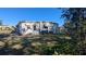 Exterior of a single-story home featuring a well-maintained lawn, landscaping, and a pleasant neighborhood setting at 1610 Reynolds Rd # 211, Lakeland, FL 33801