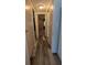 Hallway featuring updated laminate flooring and multiple closets at 1610 Reynolds Rd # 211, Lakeland, FL 33801