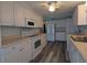 Bright kitchen with white appliances, ample cabinets and counter space, and updated laminate flooring at 1610 Reynolds Rd # 211, Lakeland, FL 33801