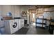 Laundry area equipped with washer, dryer, storage shelves and utility sink at 1610 Reynolds Rd # 211, Lakeland, FL 33801