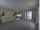 Bright living room featuring neutral carpet, an accent wall, and sliding glass doors to the sunroom at 1610 Reynolds Rd # 211, Lakeland, FL 33801