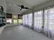 Enclosed sunroom with white walls, tile floors and sheer curtains at 1610 Reynolds Rd # 211, Lakeland, FL 33801