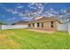 Well-maintained backyard featuring a lawn, patio, and white vinyl fence at 3226 Oak Tree Ln, Winter Haven, FL 33884