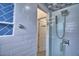 Modern bathroom featuring glass enclosed shower with blue, gray and white tiling at 3226 Oak Tree Ln, Winter Haven, FL 33884