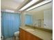Bathroom featuring a large mirror and a blue patterned shower curtain over the bath at 3226 Oak Tree Ln, Winter Haven, FL 33884