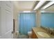 Bathroom featuring a large mirror and a blue patterned shower curtain over the bath at 3226 Oak Tree Ln, Winter Haven, FL 33884