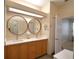Bright bathroom with double sink vanity, quartz countertop, and round mirrors at 3226 Oak Tree Ln, Winter Haven, FL 33884