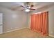 Bedroom featuring carpet floors, a ceiling fan, and peach curtains over the window at 3226 Oak Tree Ln, Winter Haven, FL 33884