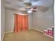 Bedroom featuring carpet floors, a ceiling fan, and peach curtains over the window at 3226 Oak Tree Ln, Winter Haven, FL 33884
