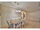 Dining area with wooden table, six white chairs, neutral walls and tile floor at 3226 Oak Tree Ln, Winter Haven, FL 33884