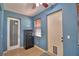 Flex room with blue walls, features a safe, door to the exterior and window with wood blinds at 3226 Oak Tree Ln, Winter Haven, FL 33884