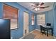 This flex space has blue walls, a ceiling fan, and a window with wood blinds at 3226 Oak Tree Ln, Winter Haven, FL 33884
