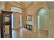 Open foyer with neutral tile flooring, display case, and view of the front door at 3226 Oak Tree Ln, Winter Haven, FL 33884