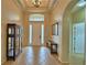 Bright and airy foyer featuring tile flooring, high ceilings, and an elegant chandelier at 3226 Oak Tree Ln, Winter Haven, FL 33884