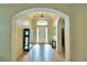 Inviting foyer showcasing arched entryways, a decorative light fixture, and tile floors at 3226 Oak Tree Ln, Winter Haven, FL 33884