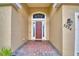 Inviting entrance to home featuring a red door, brick pavers, and decorative lighting at 3226 Oak Tree Ln, Winter Haven, FL 33884