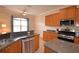 Kitchen area showcasing granite countertops, stainless steel appliances, and a breakfast bar at 3226 Oak Tree Ln, Winter Haven, FL 33884
