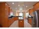 Kitchen featuring stainless appliances, an island, and ample wood cabinet storage at 3226 Oak Tree Ln, Winter Haven, FL 33884