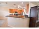 Open kitchen with stainless appliances, granite counters, wood cabinets, and breakfast bar at 3226 Oak Tree Ln, Winter Haven, FL 33884