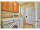 Well-equipped laundry room with washer, dryer, and ample cabinet space for storage at 3226 Oak Tree Ln, Winter Haven, FL 33884