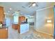 Bright living room, open concept layout with breakfast bar, stainless appliances and tan walls at 3226 Oak Tree Ln, Winter Haven, FL 33884