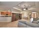 Open-concept living room showcases tile flooring, a ceiling fan, and a view of the kitchen at 3226 Oak Tree Ln, Winter Haven, FL 33884