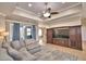 Open living room with ceiling fan, tile floors, and comfortable gray sofa at 3226 Oak Tree Ln, Winter Haven, FL 33884