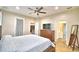 Spacious main bedroom with a ceiling fan, carpeted floors and an ensuite bathroom at 3226 Oak Tree Ln, Winter Haven, FL 33884